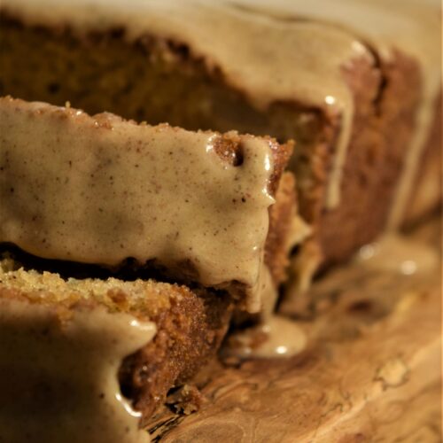 close up vanilla chai pear bread spice icing glaze silver pie server vintage warm browns cozy baking board