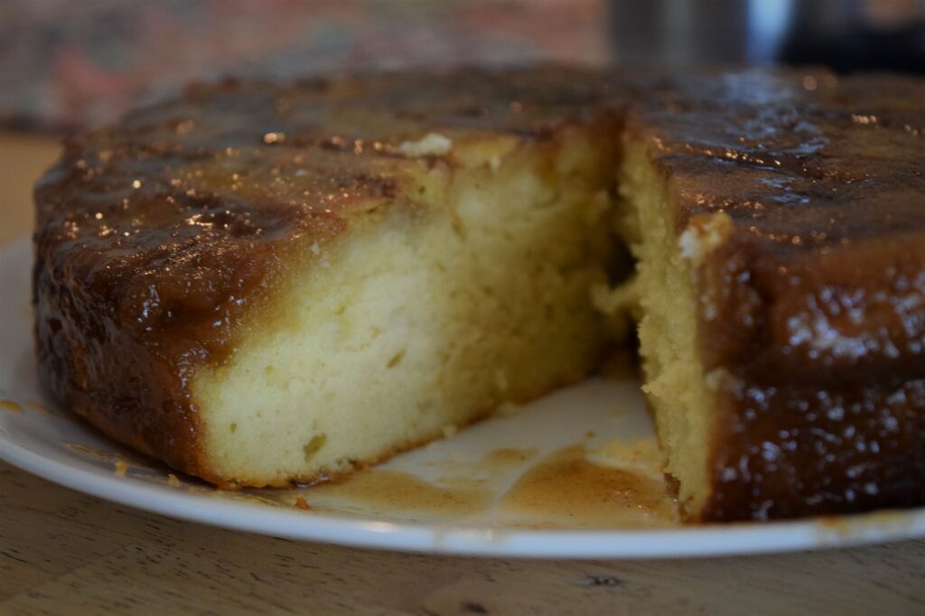 Bananas Foster Upside Down Cake, island, tropical, summer, kitchen, hands slicing cake, dessert, baking, rum, spice, easy, simple