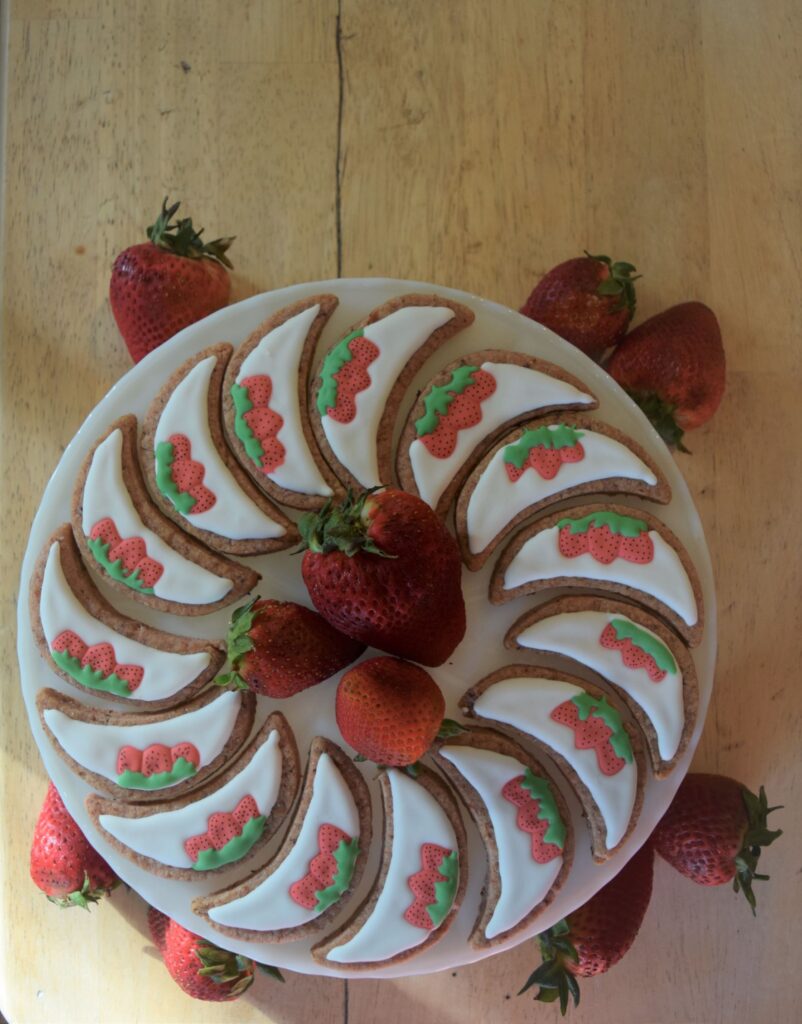 strawberry moon cookies royal icing, decorating, spiral, red, baking, recipes, cake stand, swirl, vintage dessert, fruit, food styling, wood table