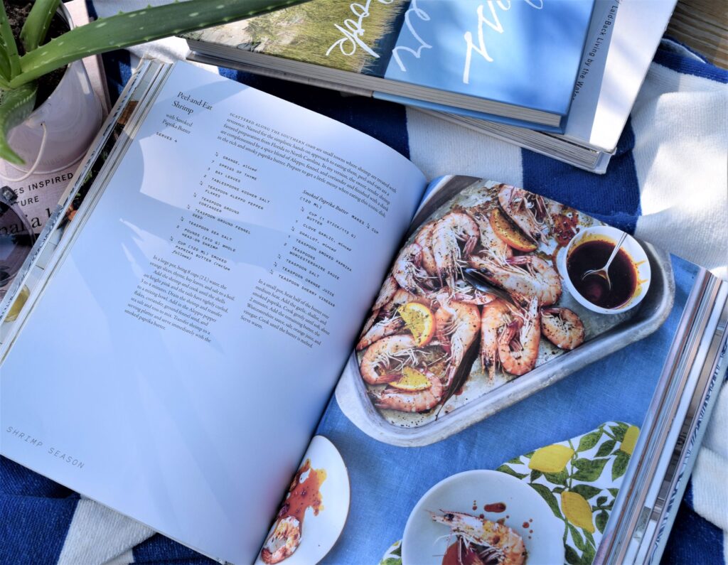 summer reads book list, explores, adventure, food, cooking, home, sunny, sunglasses, blue and pink, shrimp, coastal cooking