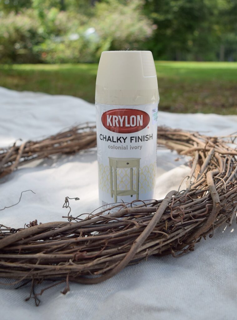 krylon chalky finish spray paint in colonial crea, DIY project, grapevine wreath form base on canvas drop cloth, calm, product shot, muted, outside, fall crafts, decor, wreath making tutorial