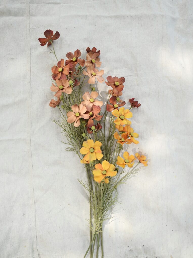 fall florals, gold and rust wildflower stems on canvas backdrop, clean and minimalist, wreath supplies