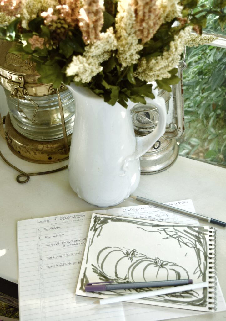 Slow living routine rhythm, vase of white summer flowers, list, sketching pumpkins